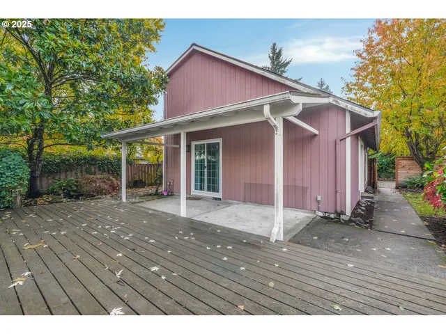 a backyard of a house with table and chairs