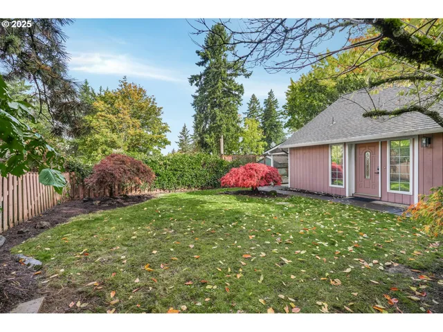 a view of a house with a backyard and garage