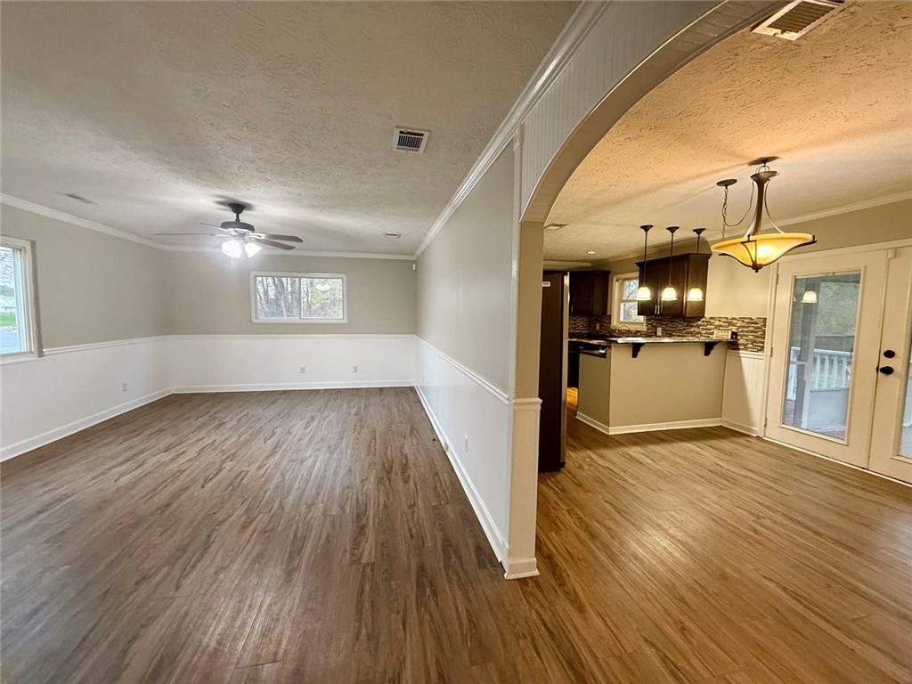 1801 Dews Pond Road Southeast Calhoun, GA 30701 - Photo 3 of 16 a view of a big room with wooden floor and a kitchen