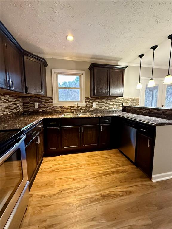 1801 Dews Pond Road Southeast Calhoun, GA 30701 - Photo 5 of 16 a large kitchen with stainless steel appliances granite countertop a stove and a sink