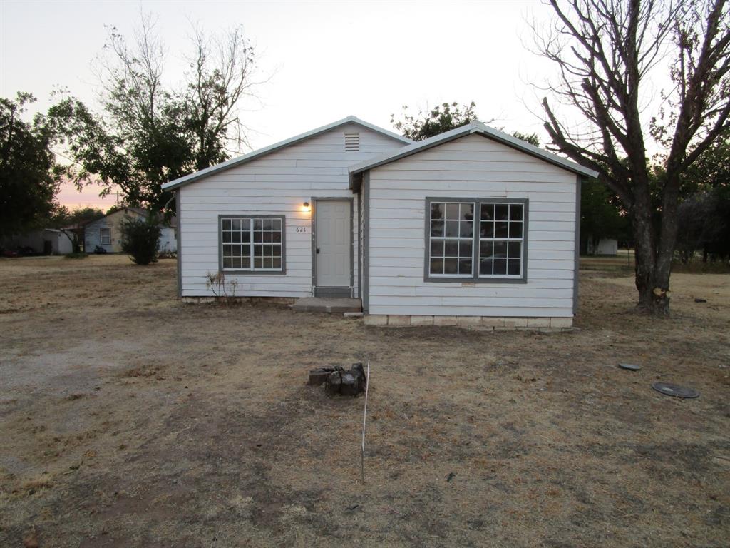 front view of a house with a yard and garage