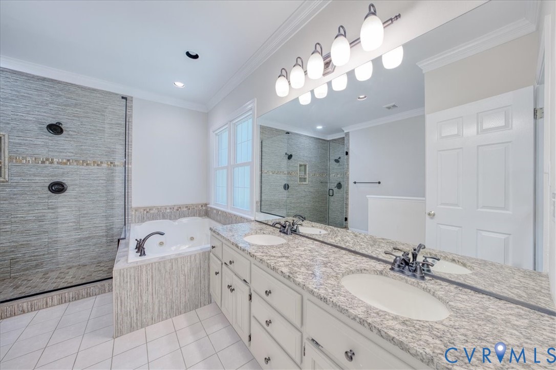1813 Gildenborough Court Midlothian, VA 23113 - Photo 17 of 46 a spacious bathroom with a granite countertop double vanity sink a mirror a bathtub and shower