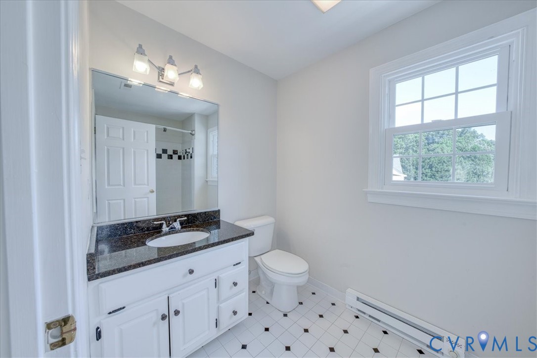 1813 Gildenborough Court Midlothian, VA 23113 - Photo 25 of 46 a bathroom with a granite countertop sink a toilet a window and a mirror
