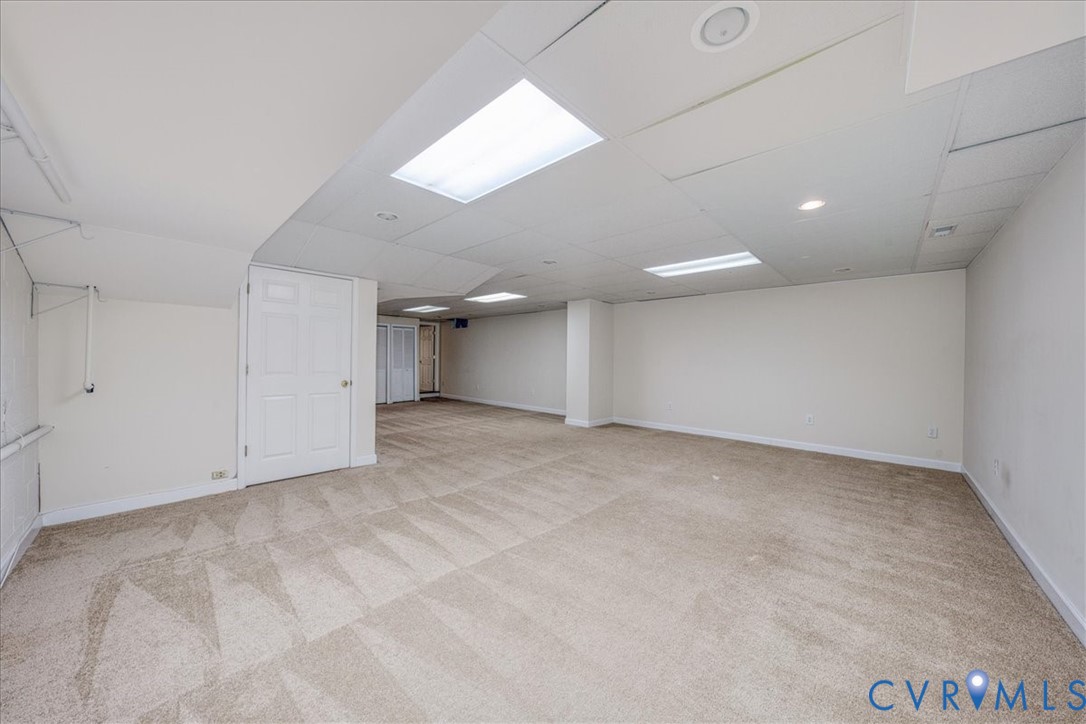 1813 Gildenborough Court Midlothian, VA 23113 - Photo 38 of 46 an empty room with a chandelier fan and windows
