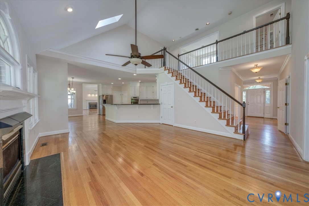 1813 Gildenborough Court Midlothian, VA 23113 - Photo 7 of 46 a view of a hallway with wooden floor and a kitchen space