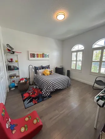 a bedroom with furniture and a wooden floor