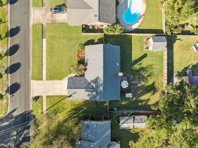 an aerial view of residential house with outdoor space and swimming pool