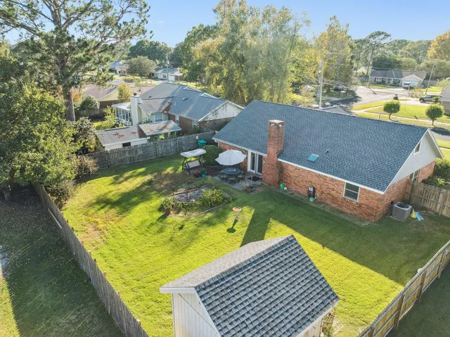 an aerial view of residential houses with outdoor space and swimming pool