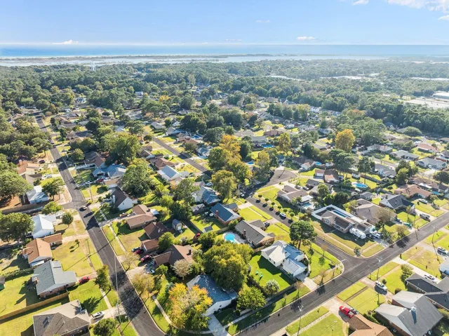 an aerial view of residential building with green space
