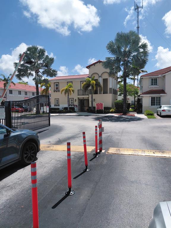 21205 Northwest 14th Place, Unit 319 Miami, FL 33169 - Photo 13 of 14 a view of a street with is parked