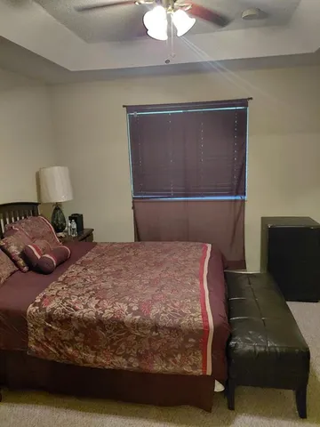 a bedroom with a bed and a lamp