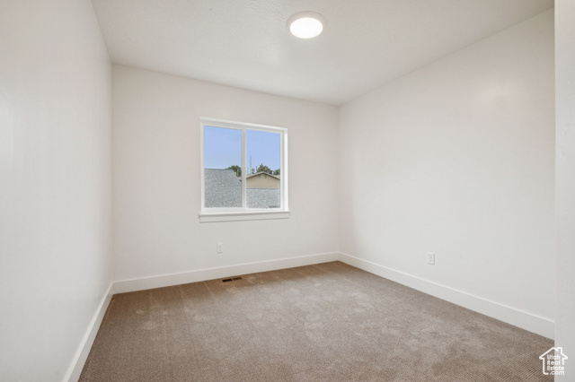 1615 North Angel Street, Unit F Layton, UT 84041 - Photo 8 of 45 Empty room featuring light colored carpet and baseboards