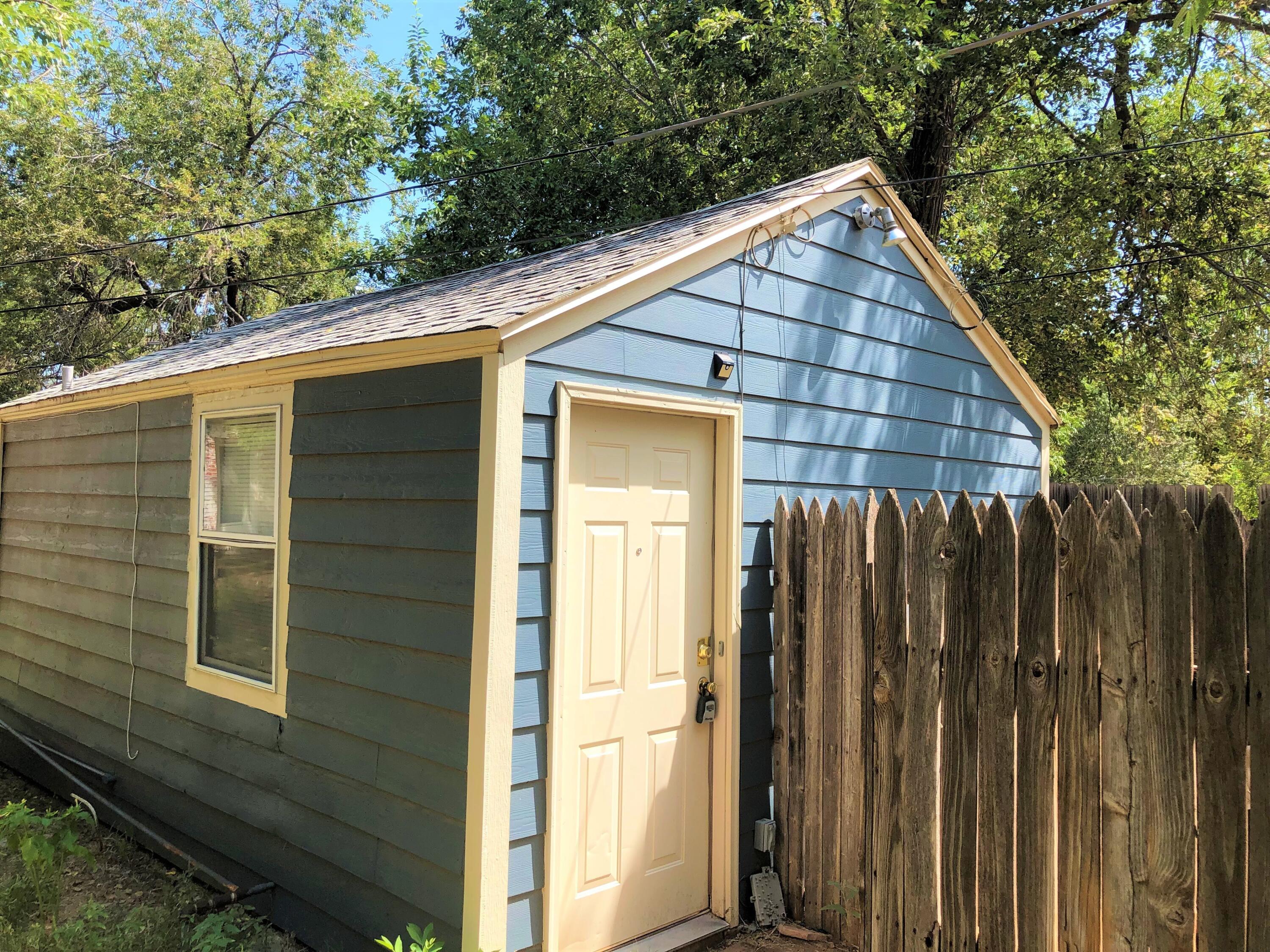 2513 21st Street, Unit REAR Lubbock, TX 79410 - Photo 1 of 5 a view of a house with wooden fence and large windows