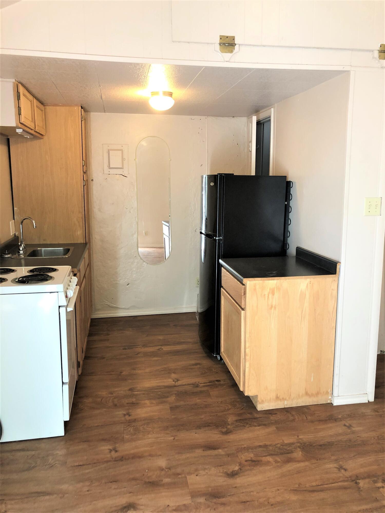 2513 21st Street, Unit REAR Lubbock, TX 79410 - Photo 2 of 5 a view of a kitchen with wooden floor and a sink
