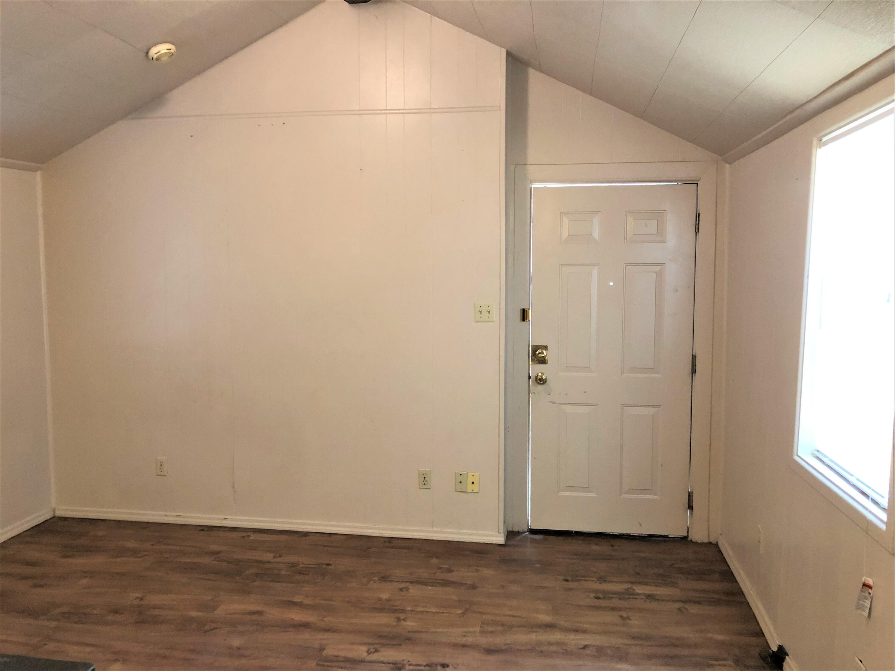 2513 21st Street, Unit REAR Lubbock, TX 79410 - Photo 3 of 5 a view of an empty room with wooden floor