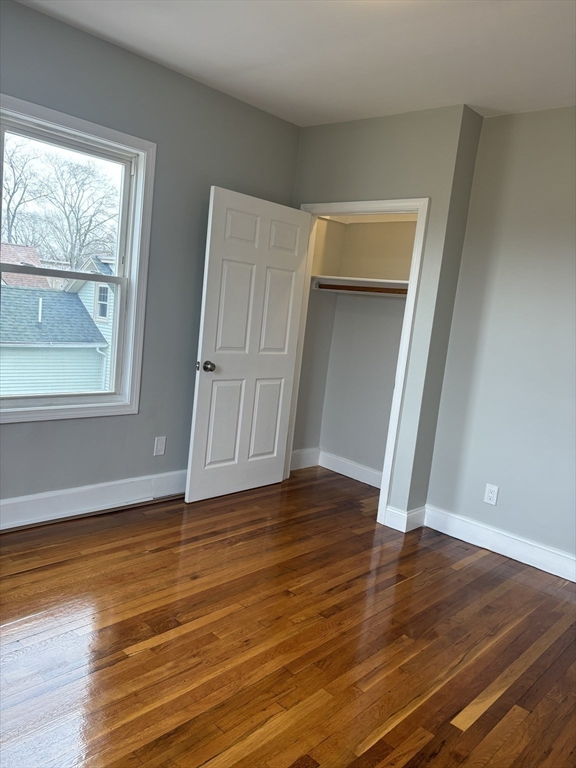 63 Callender Street, Unit 3R Boston, MA 02124 - Photo 11 of 24 a view of an empty room with wooden floor and a window