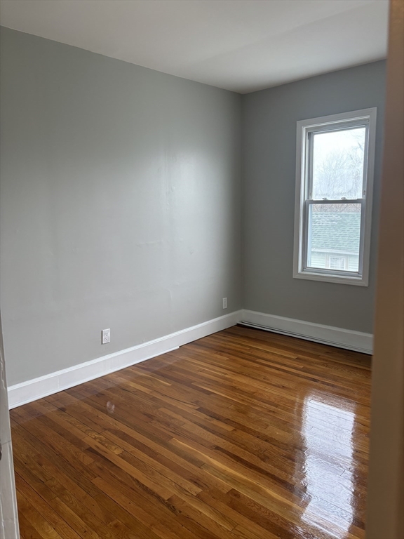 63 Callender Street, Unit 3R Boston, MA 02124 - Photo 13 of 24 a view of empty room with wooden floor and fan