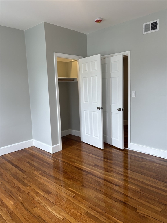 63 Callender Street, Unit 3R Boston, MA 02124 - Photo 14 of 24 a view of an empty room with wooden floor and closet