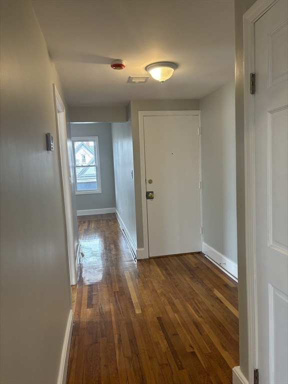 63 Callender Street, Unit 3R Boston, MA 02124 - Photo 16 of 24 a view of a room with wooden floor a sink and staircase