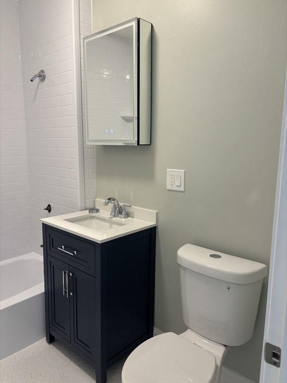63 Callender Street, Unit 3R Boston, MA 02124 - Photo 17 of 24 a bathroom with a toilet sink and mirror