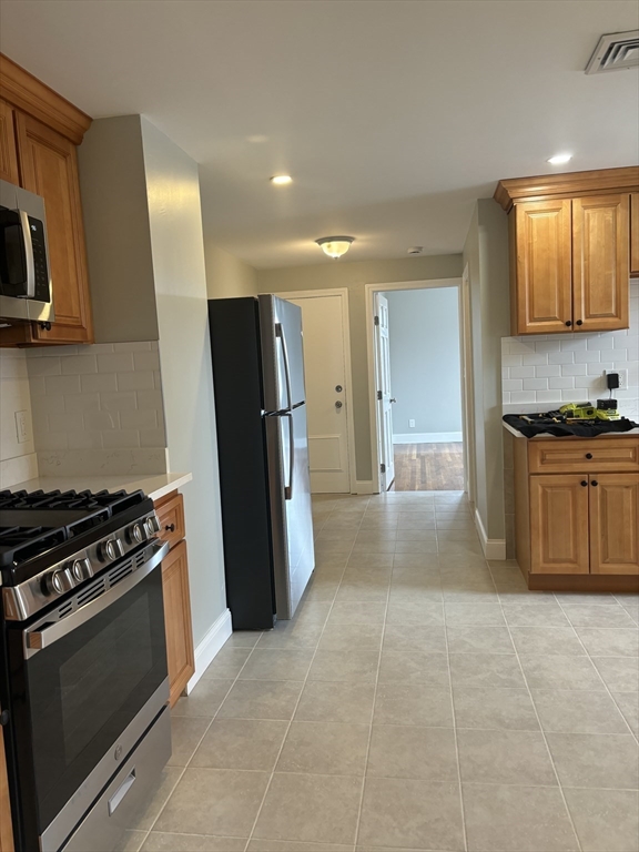 63 Callender Street, Unit 3R Boston, MA 02124 - Photo 3 of 24 a kitchen with stainless steel appliances a stove a refrigerator and a sink
