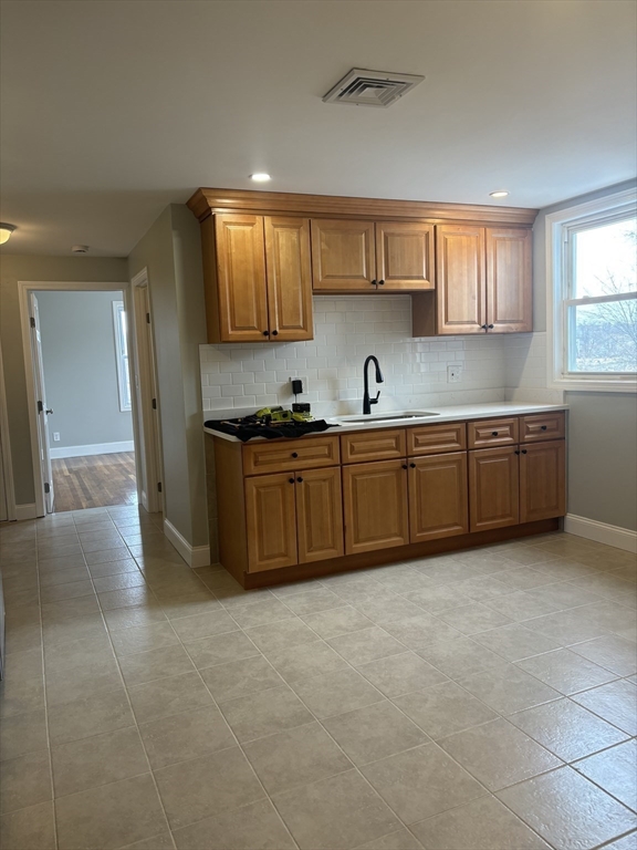 63 Callender Street, Unit 3R Boston, MA 02124 - Photo 4 of 24 a kitchen with stainless steel appliances granite countertop a sink and cabinets