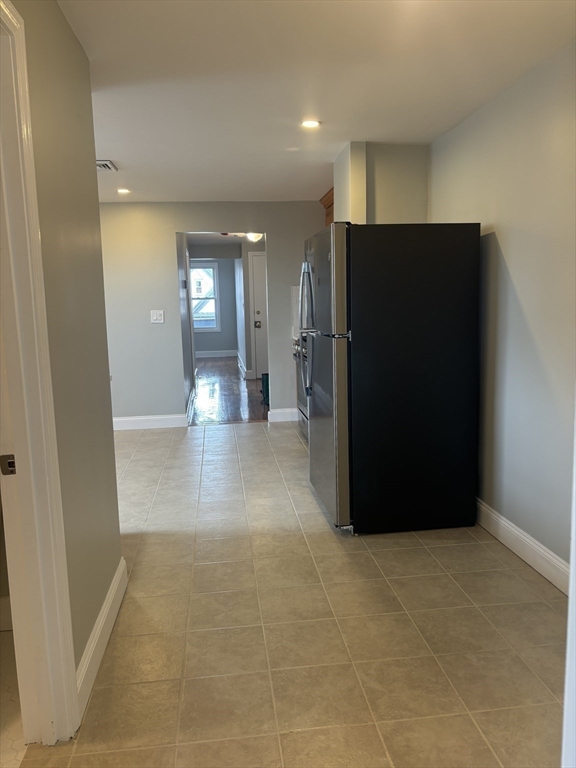 63 Callender Street, Unit 3R Boston, MA 02124 - Photo 10 of 24 a view of a hallway with wooden shelves