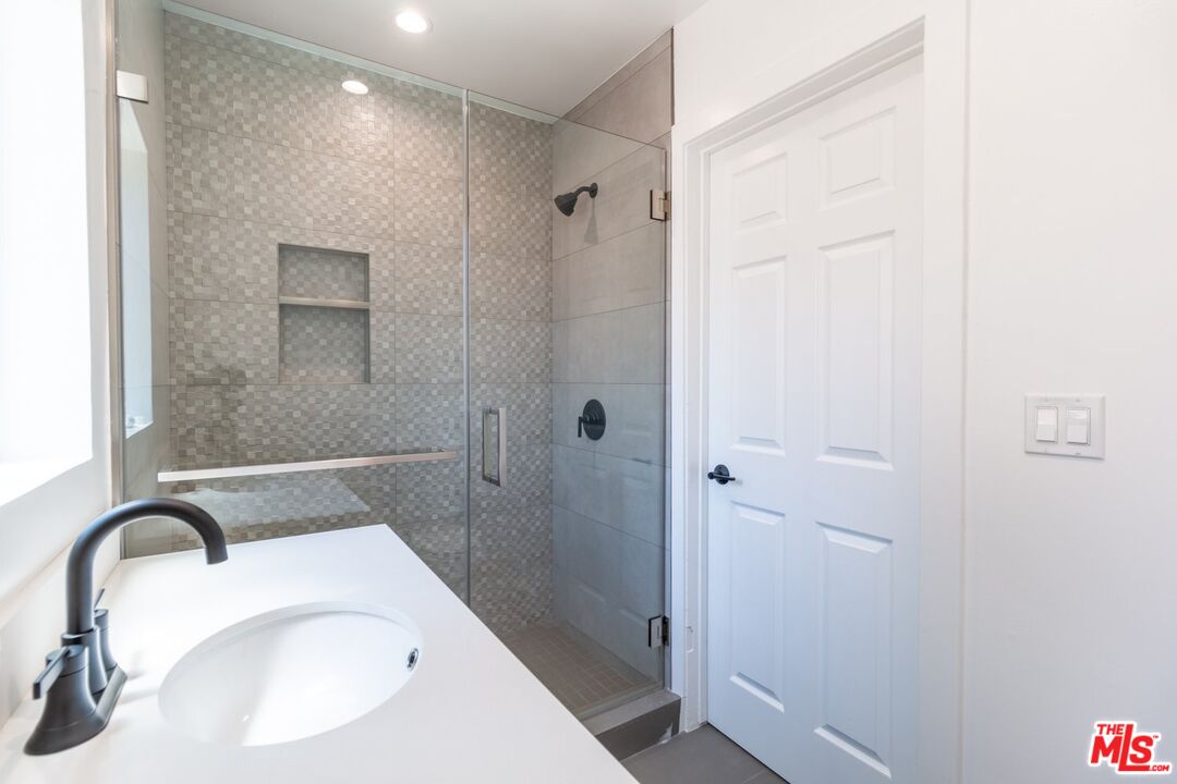 9416 Ruffner Avenue Northridge, CA 91343 - Photo 11 of 27 a bathroom with a sink and shower
