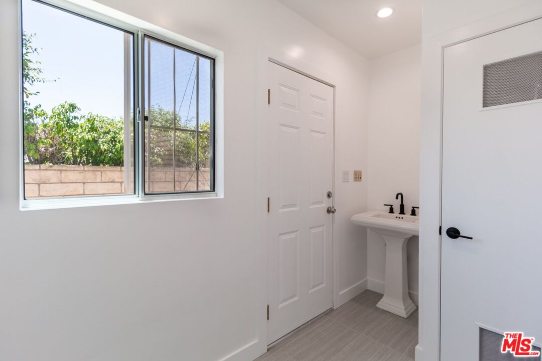 9416 Ruffner Avenue Northridge, CA 91343 - Photo 12 of 27 a bathroom with a sink and a mirror