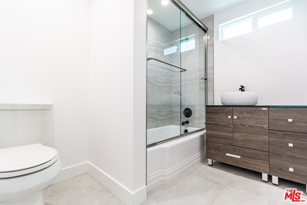 9416 Ruffner Avenue Northridge, CA 91343 - Photo 15 of 27 a bathroom with a bathtub a toilet and a shower