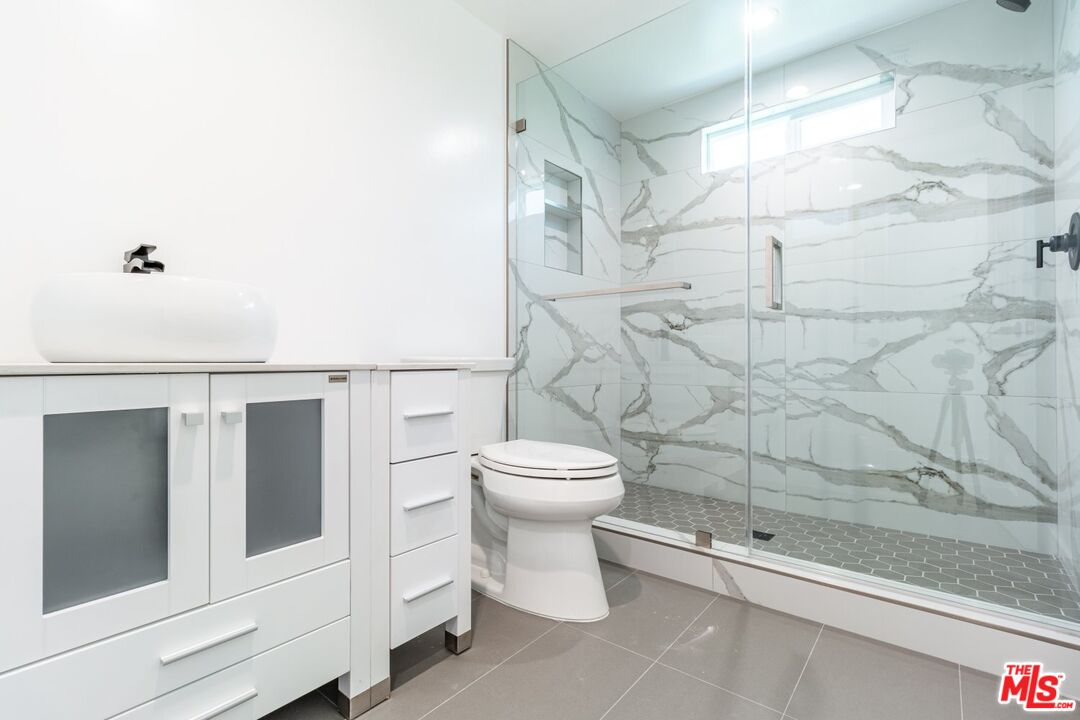 9416 Ruffner Avenue Northridge, CA 91343 - Photo 16 of 27 a bathroom with a toilet and a shower