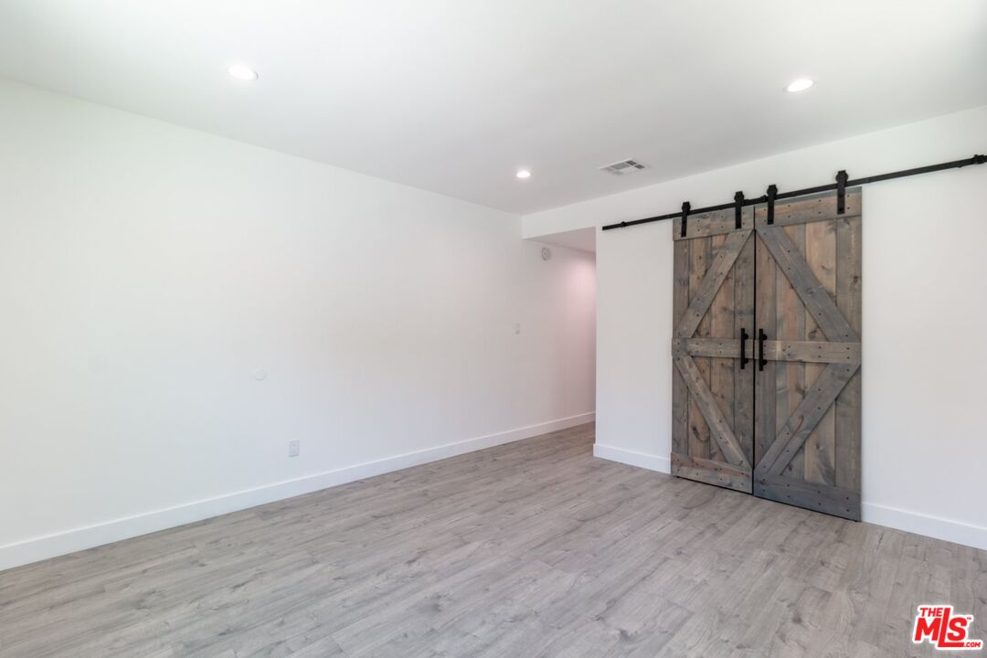 9416 Ruffner Avenue Northridge, CA 91343 - Photo 18 of 27 a view of a room with wooden floor and white walls