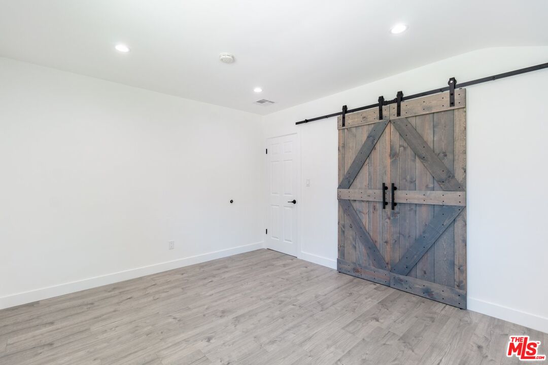 9416 Ruffner Avenue Northridge, CA 91343 - Photo 20 of 27 a view of a room with wooden floor and entryway