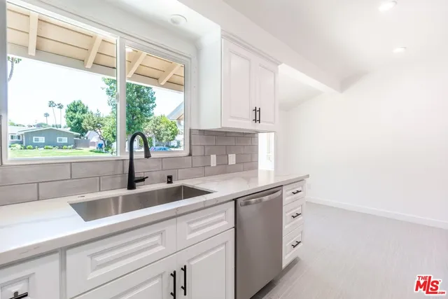 a front view of a house with a garden and yard