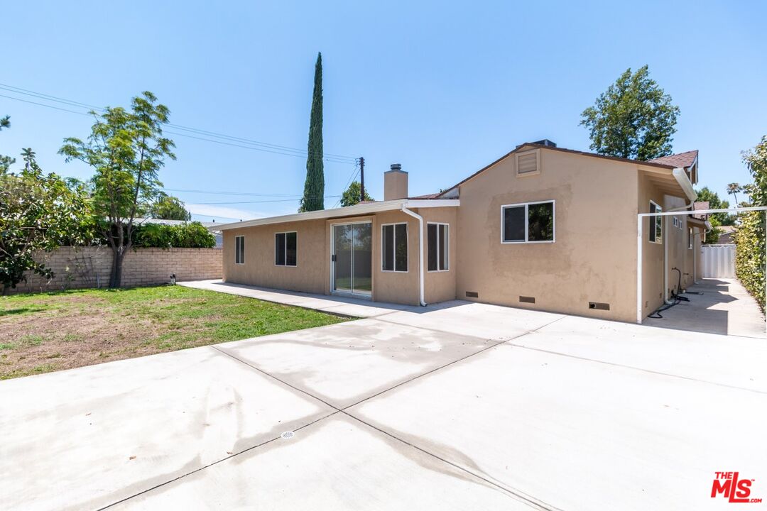 9416 Ruffner Avenue Northridge, CA 91343 - Photo 25 of 27 a front view of a house with a garden and yard