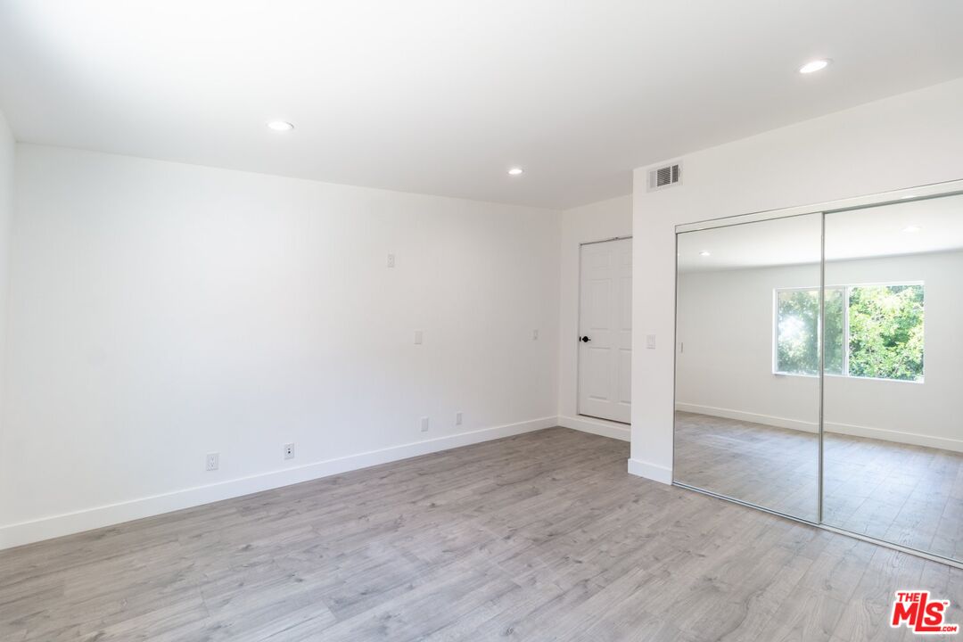 9416 Ruffner Avenue Northridge, CA 91343 - Photo 8 of 27 wooden floor in an empty room with a window