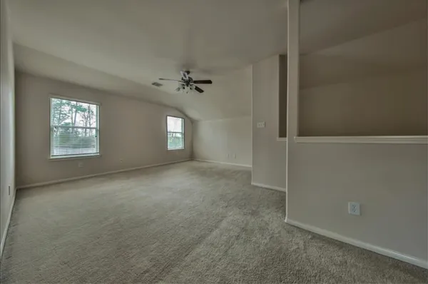 an empty room with windows and closet