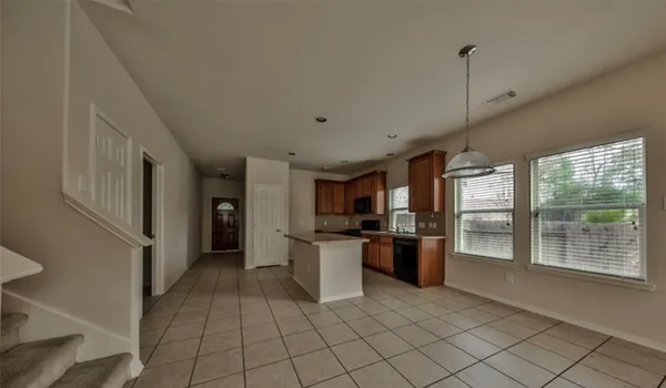 a kitchen with a refrigerator and a sink