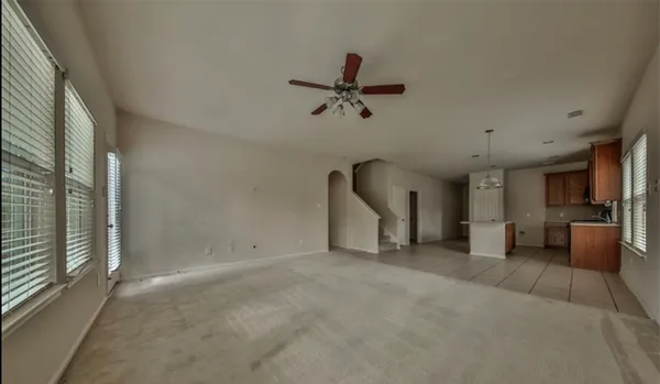 a view of a livingroom with furniture and a ceiling fan