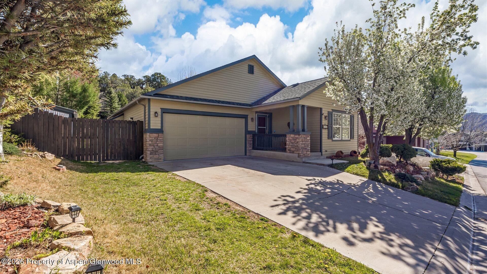 606 Lariat Loop New Castle, CO 81647 - Photo 26 of 27 a front view of a house with a yard and garage