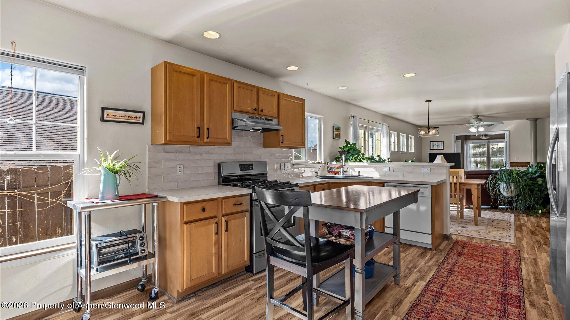 606 Lariat Loop New Castle, CO 81647 - Photo 9 of 27 a kitchen with a table chairs stove and cabinets