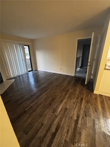 a view of an empty room and wooden floor