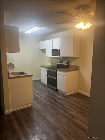 a kitchen with granite countertop a stove and a sink