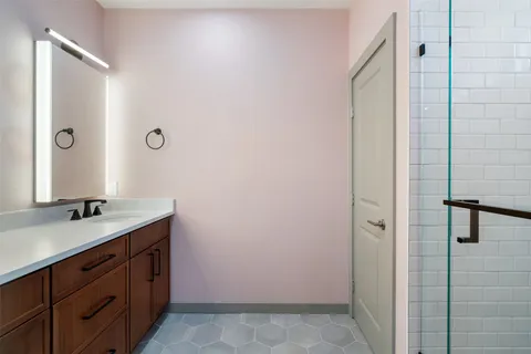a bathroom with a granite countertop sink and a mirror