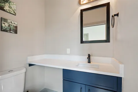 a bathroom with a sink a vanity and a toilet