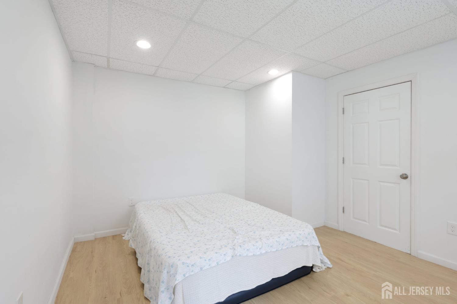 36 Henry Street Edison, NJ 08820 - Photo 31 of 42 a bedroom with a bed and a night stand