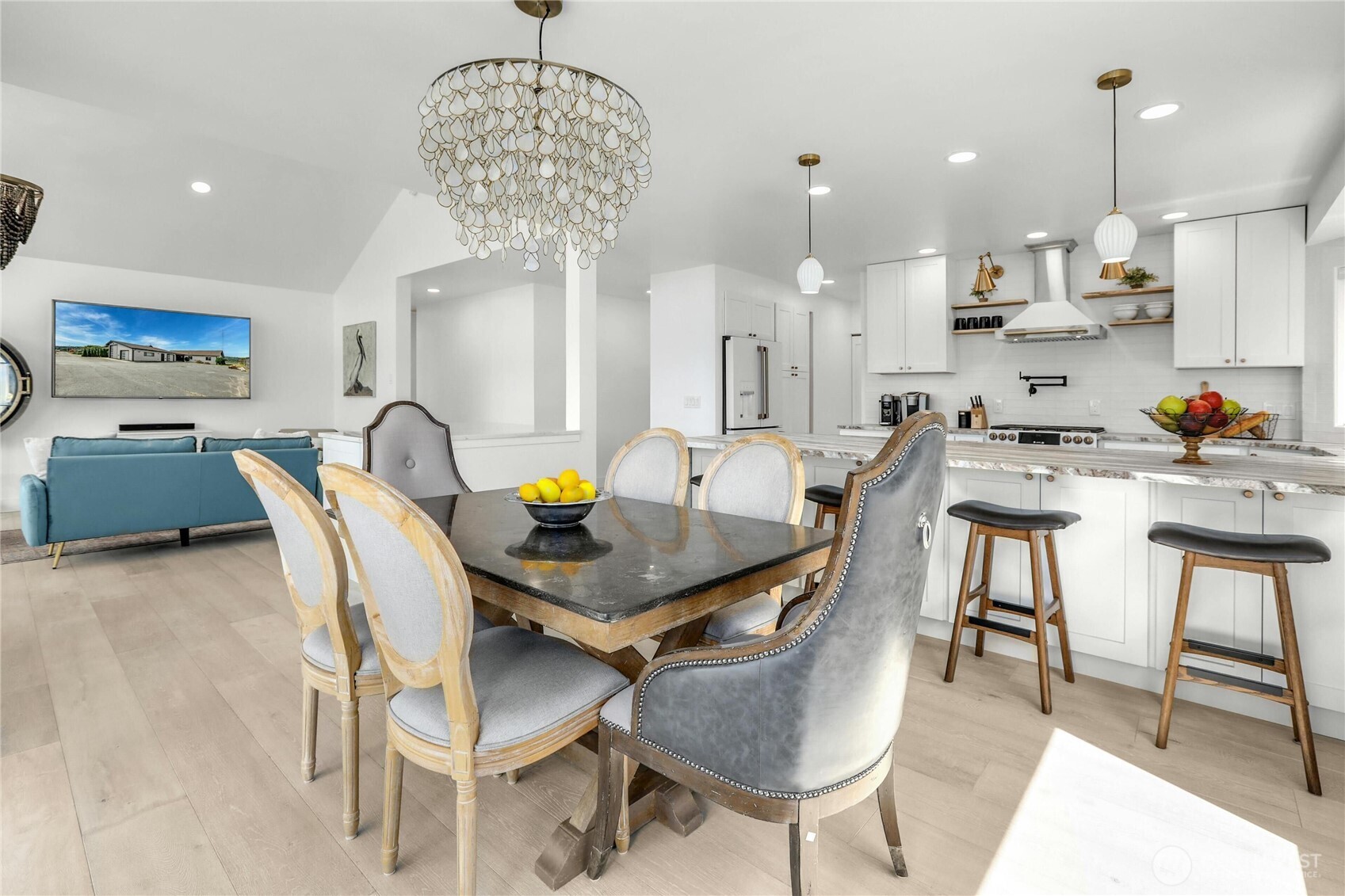14938 Channel Lane La Conner, WA 98257 - Photo 11 of 40 a view of a dining room and livingroom with furniture wooden floor a chandelier