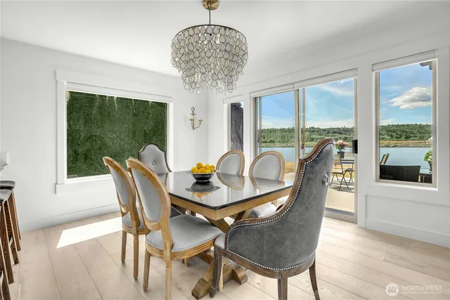 a dining room with furniture a chandelier and wooden floor