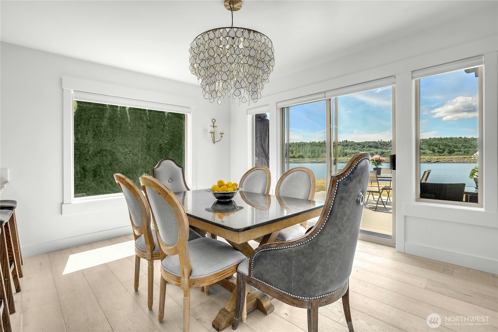 14938 Channel Lane La Conner, WA 98257 - Photo 12 of 40 a dining room with furniture a chandelier and wooden floor