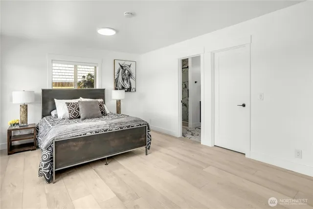 a spacious bedroom with a bed and window